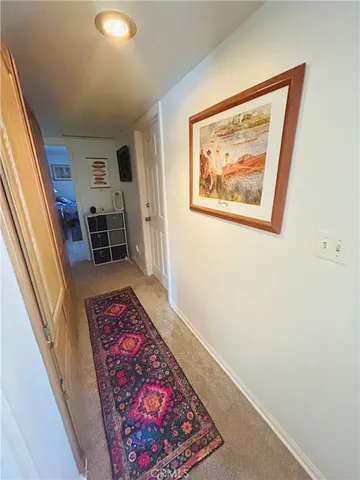 a living room with a stove and a painting on the wall