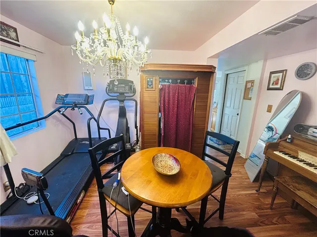 a view of a dining room with furniture and chandelier
