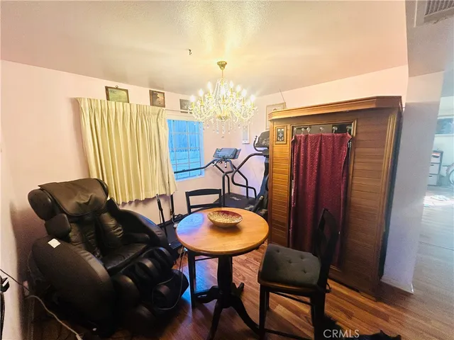 a living room with furniture a chandelier and a window