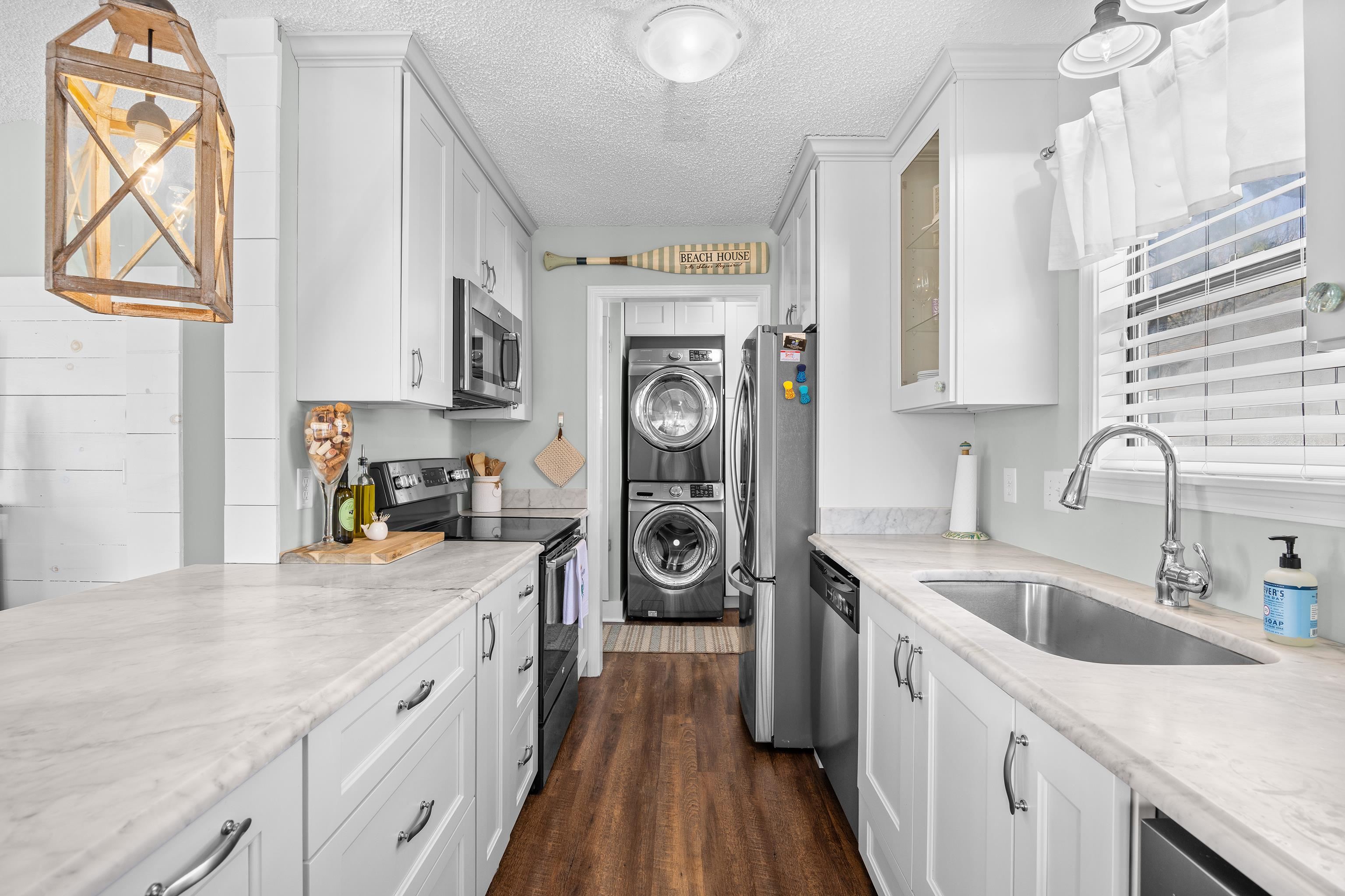817 Main Sail Court Murrells Inlet, SC 29576 - Photo 11 of 35 Kitchen featuring decorative light fixtures, appliances with stainless steel finishes, a textured ceiling, white cabinetry, and glass insert cabinets