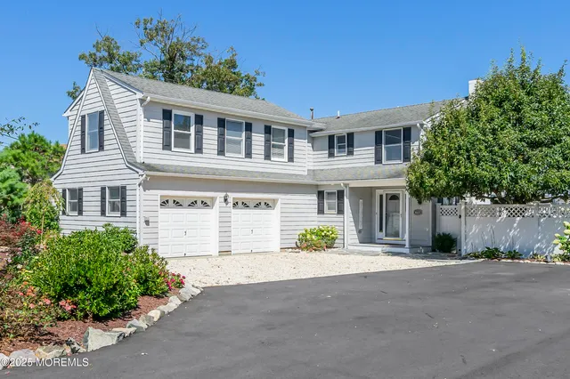 a front view of a house with a yard and a garage