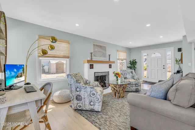 a living room with fireplace furniture and a wooden floor