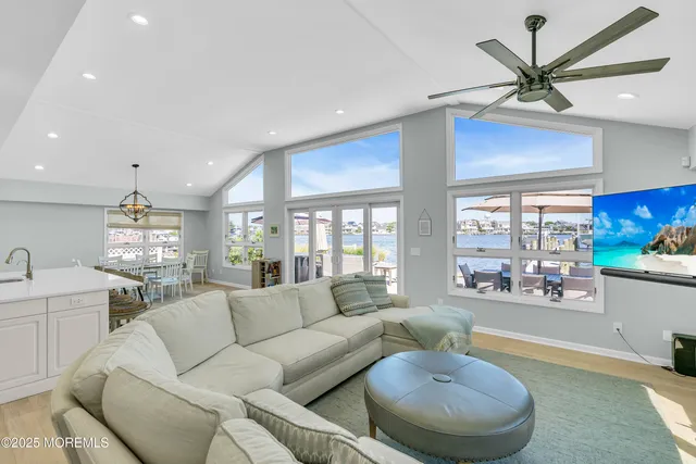 a living room with furniture a chandelier and a large window