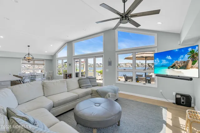 a living room with furniture a chandelier and a large window