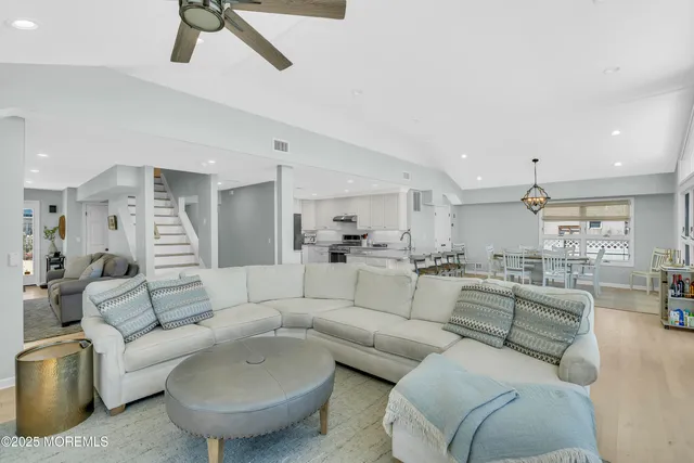 a living room with furniture and a view of kitchen
