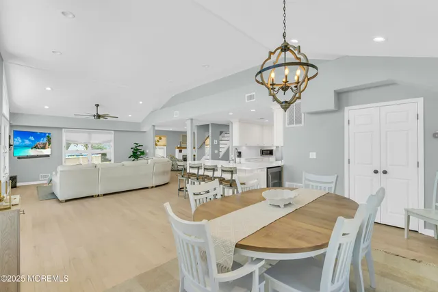 a view of a dining room with furniture wooden floor and chandelier