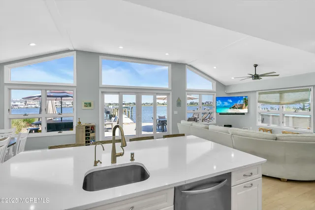 a kitchen with stainless steel appliances a sink and a large window