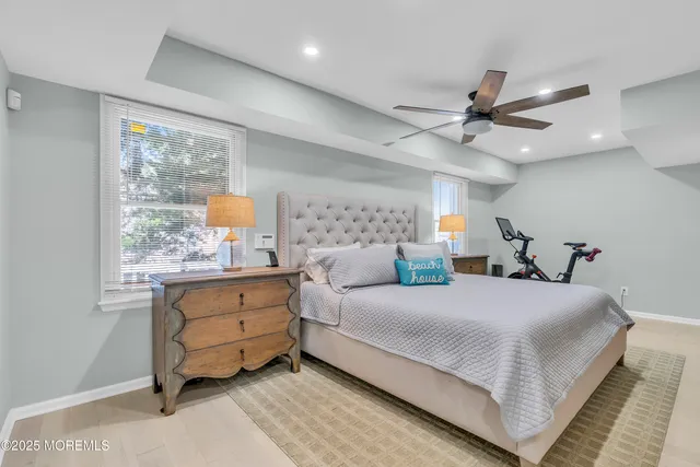 a bedroom with a large bed and a chandelier