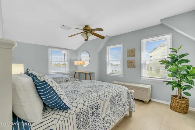 a bedroom with a bed a chandelier and a mirror