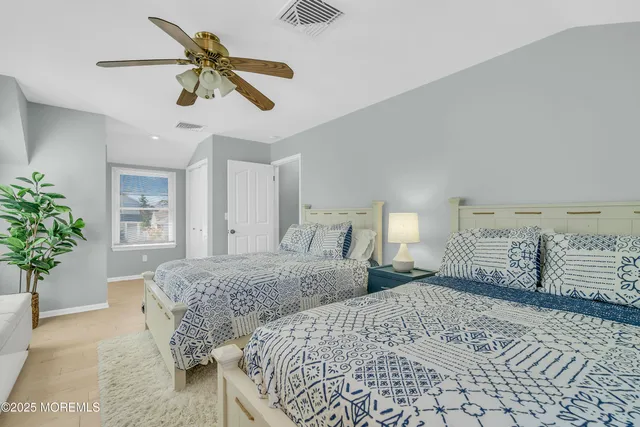 a bedroom with a large bed and a chandelier