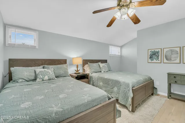 a view of a livingroom with wooden floor and a ceiling fan