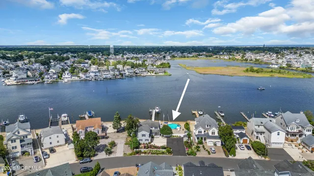 an aerial view of a house with a swimming pool outdoor seating and yard