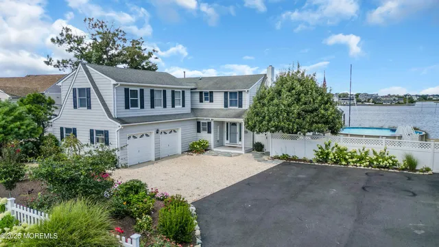 a front view of a house with a garden and mountain view