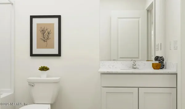 a bathroom with a sink a toilet and mirror