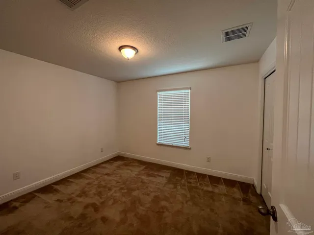 an empty room with a empty space and windows