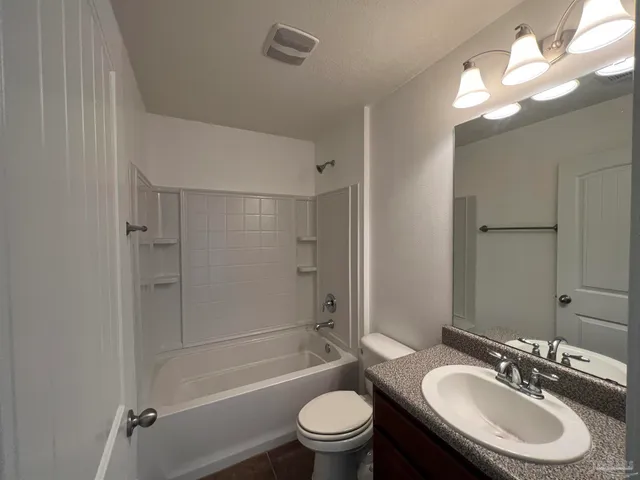 a bathroom with a sink toilet tub and shower