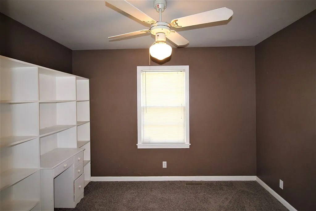 4317 Byron Street Columbus, GA 31907 - Photo 15 of 28 an empty room with a window and ceiling fan