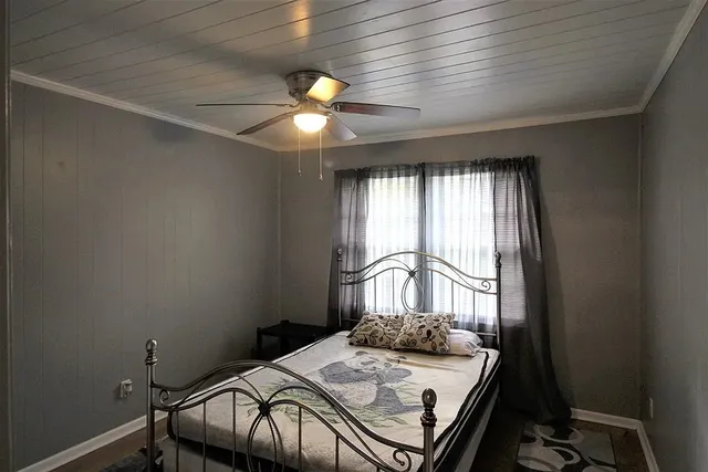 a bedroom with a bed and a window