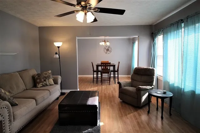 a living room with furniture and a lamp