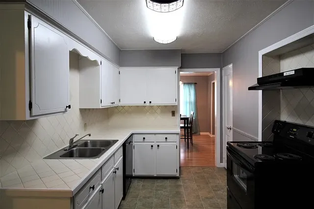 a kitchen with a stove and a refrigerator