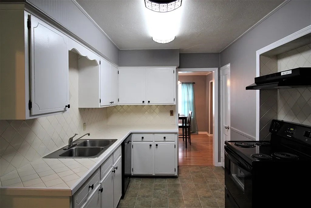 4317 Byron Street Columbus, GA 31907 - Photo 7 of 28 a kitchen with a stove and a refrigerator
