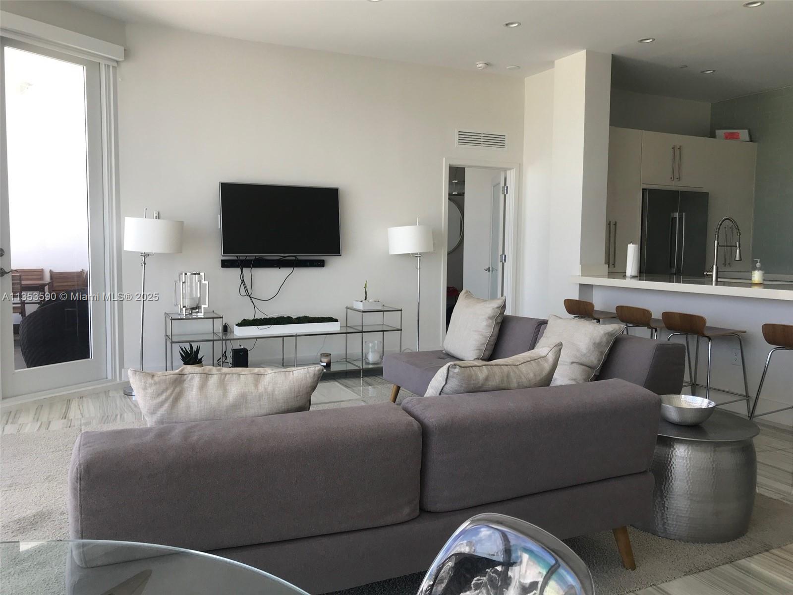 100 Lincoln Road, Unit PH9 Miami Beach, FL 33139 - Photo 15 of 83 a living room with furniture and a flat screen tv