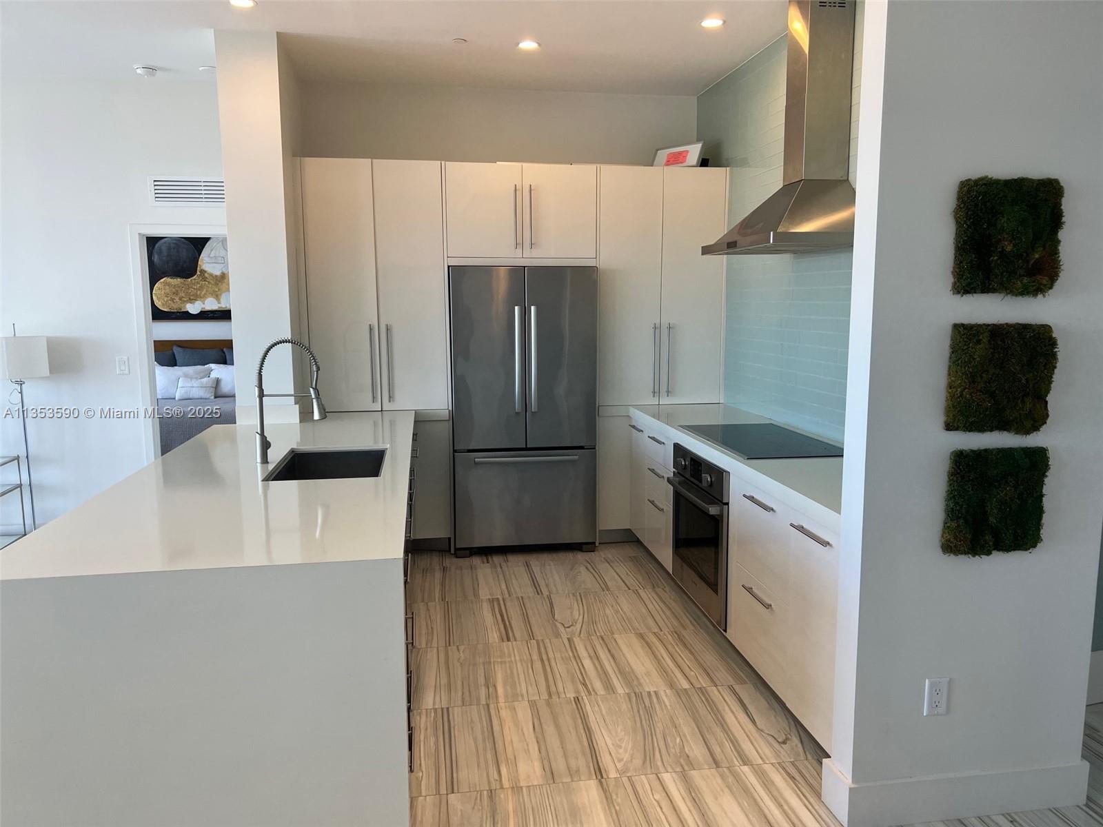 100 Lincoln Road, Unit PH9 Miami Beach, FL 33139 - Photo 20 of 83 a kitchen with stainless steel appliances a refrigerator and a stove top oven
