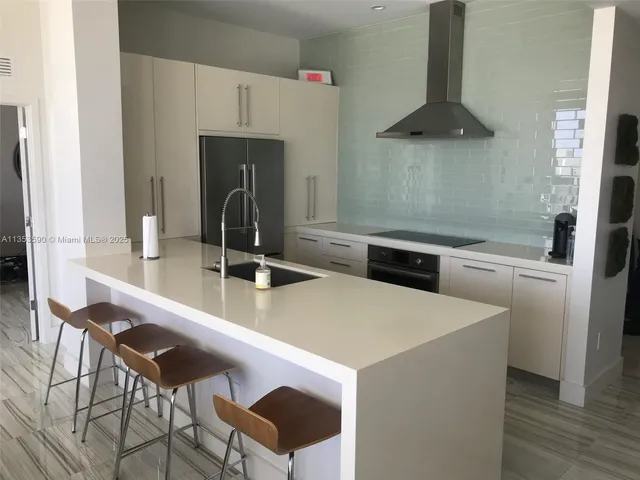 a bathroom with a double vanity sink mirror and shower