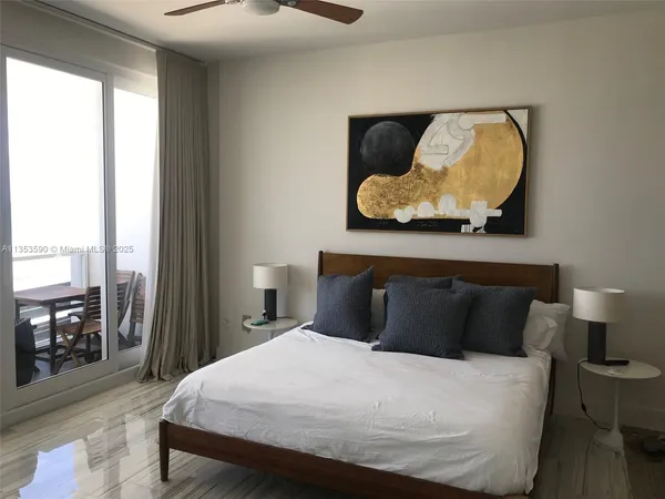 a bedroom with a large bed and a large window