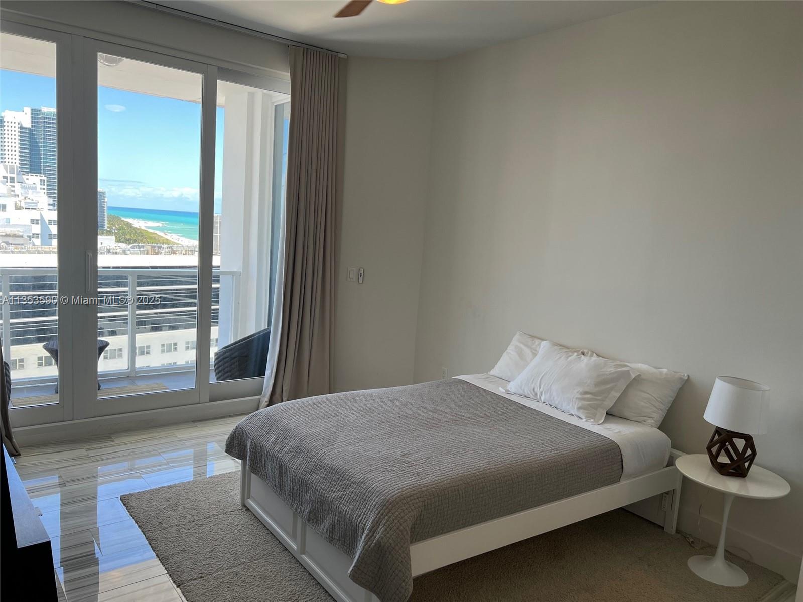 100 Lincoln Road, Unit PH9 Miami Beach, FL 33139 - Photo 33 of 83 a bedroom with a large bed and a large window