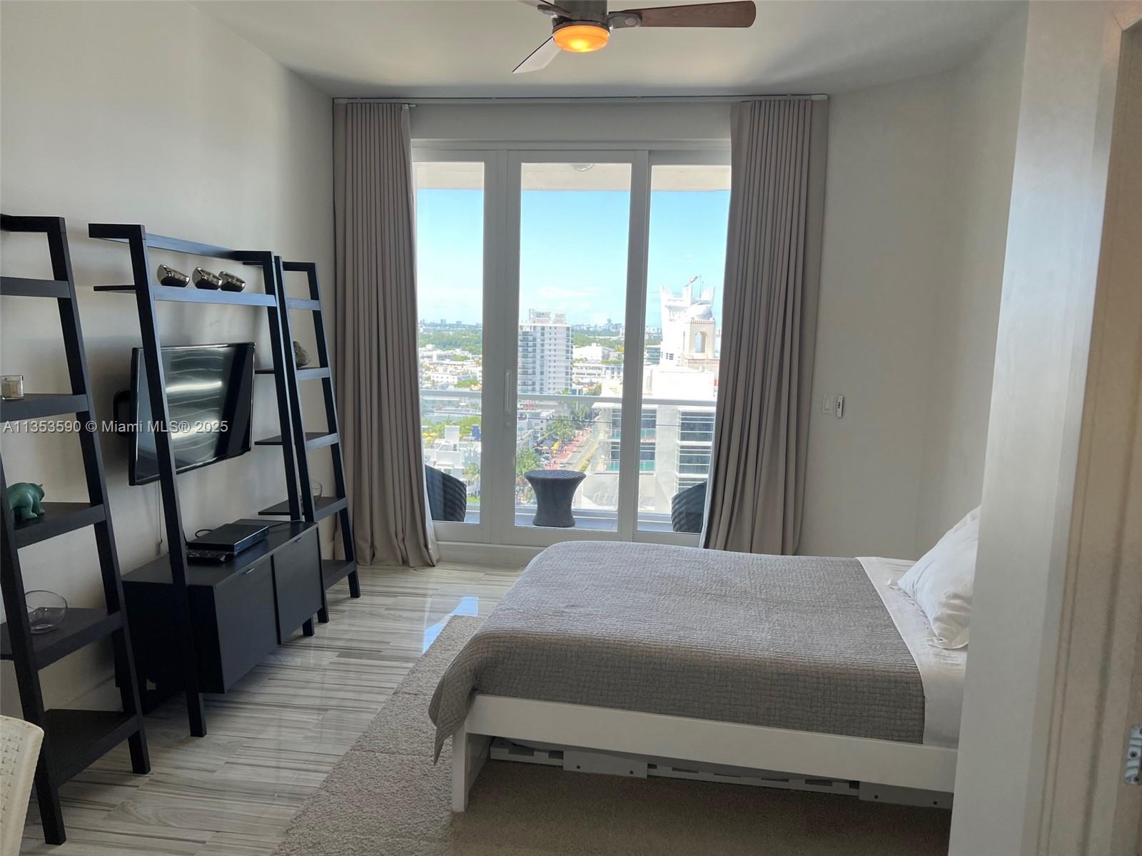 100 Lincoln Road, Unit PH9 Miami Beach, FL 33139 - Photo 35 of 83 a bedroom with a large bed and a large window