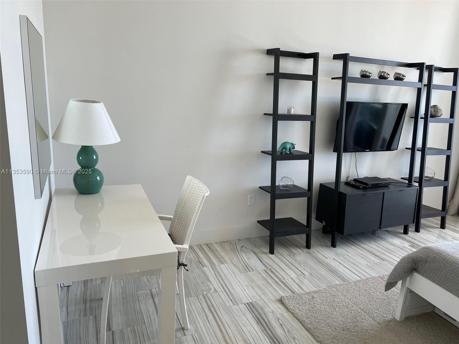 100 Lincoln Road, Unit PH9 Miami Beach, FL 33139 - Photo 36 of 83 a view of a workspace with furniture and wooden floor