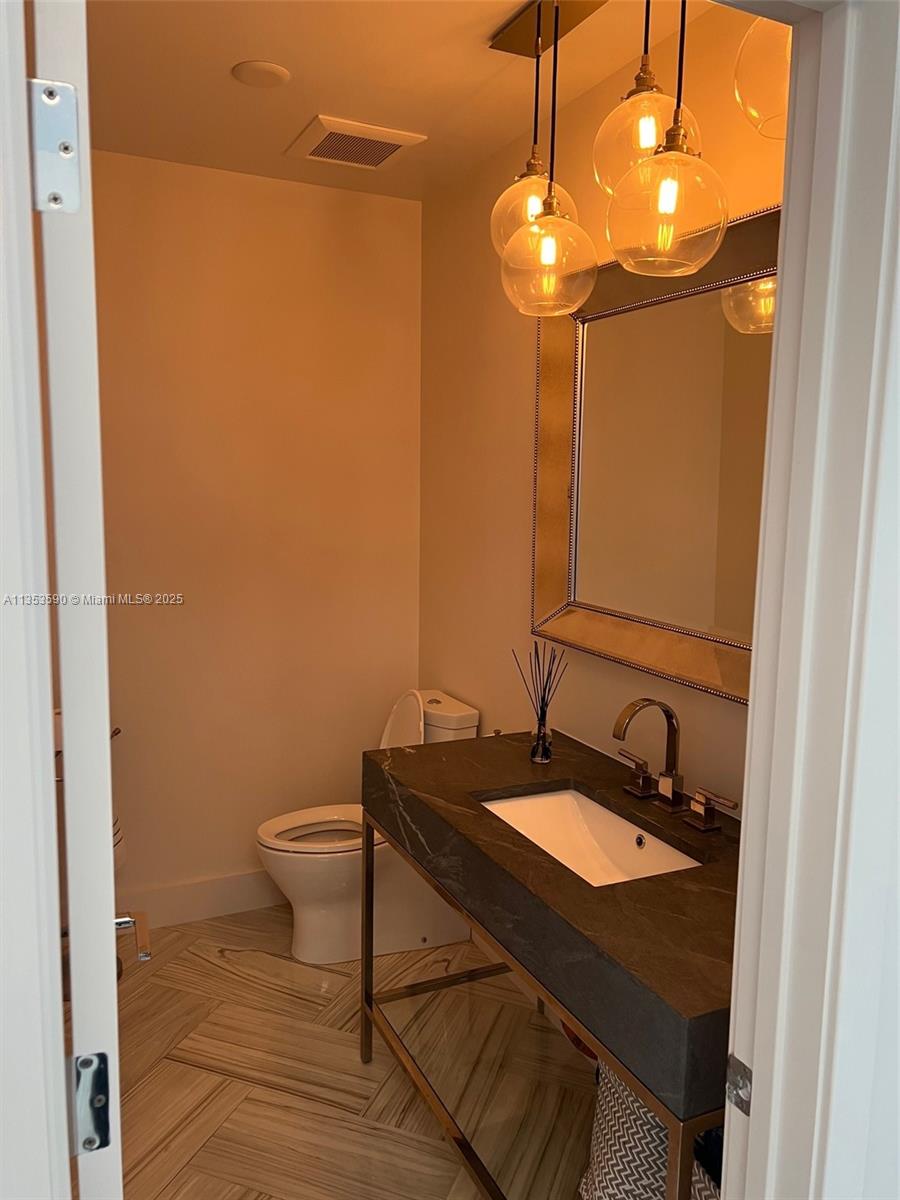 100 Lincoln Road, Unit PH9 Miami Beach, FL 33139 - Photo 40 of 83 a bathroom with a sink a toilet and mirror