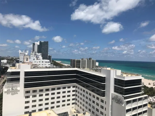 a view of swimming pool with outdoor seating and city view