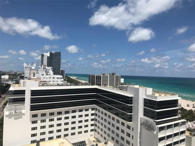 a view of swimming pool with outdoor seating and city view