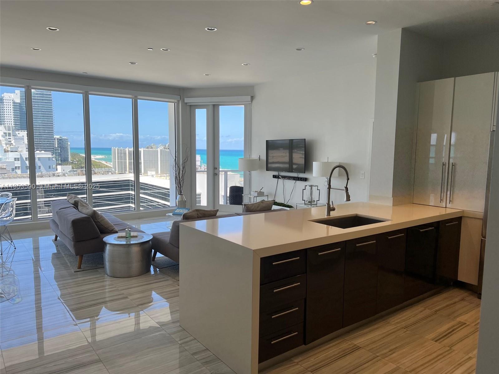 100 Lincoln Road, Unit PH9 Miami Beach, FL 33139 - Photo 6 of 83 a kitchen with a sink and cabinets