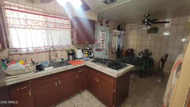 a kitchen with a sink stove and cabinets