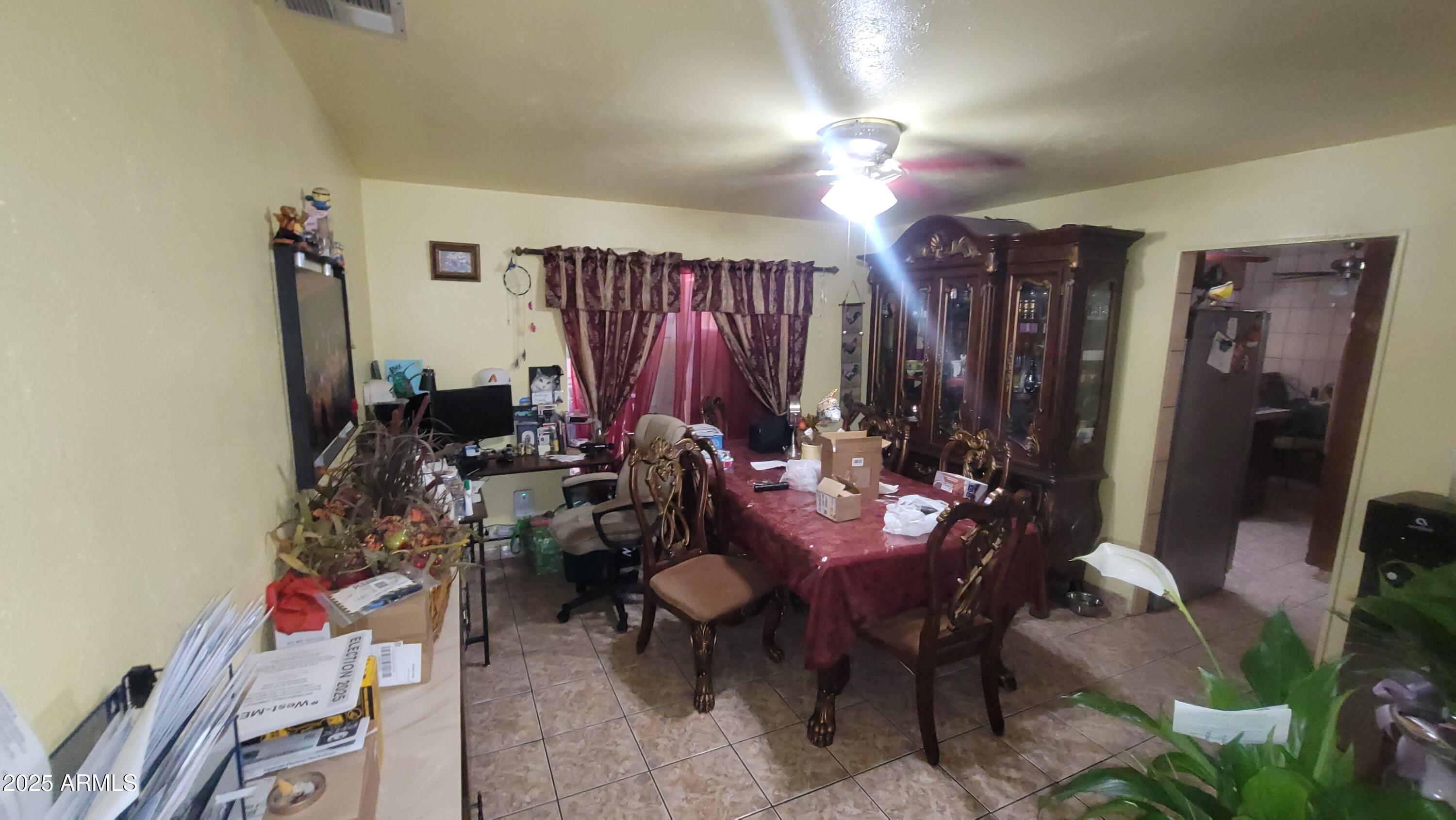 4315 West Osborn Road Phoenix, AZ 85031 - Photo 18 of 29 a view of a dining room with furniture and chandelier
