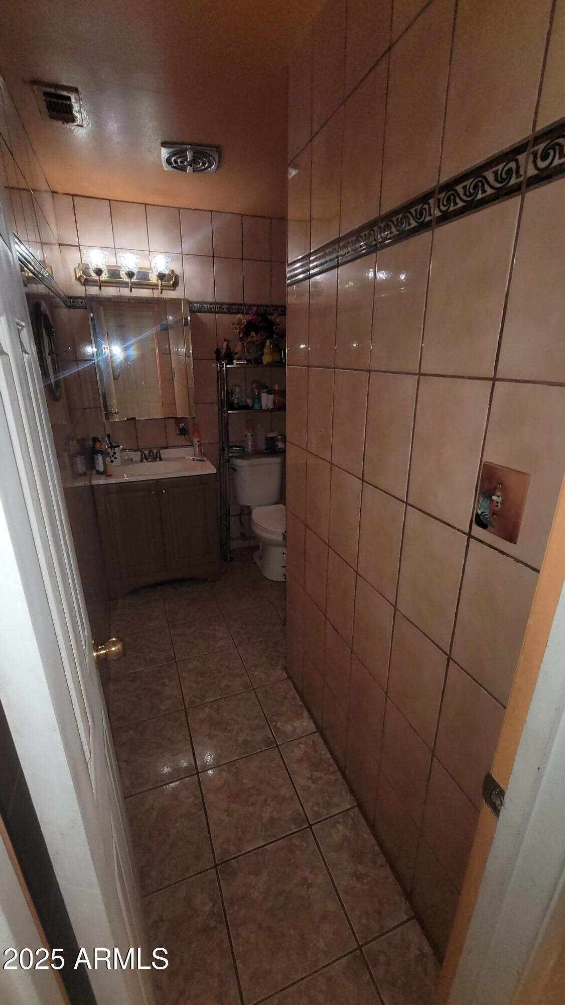 4315 West Osborn Road Phoenix, AZ 85031 - Photo 23 of 29 a kitchen with refrigerator and table