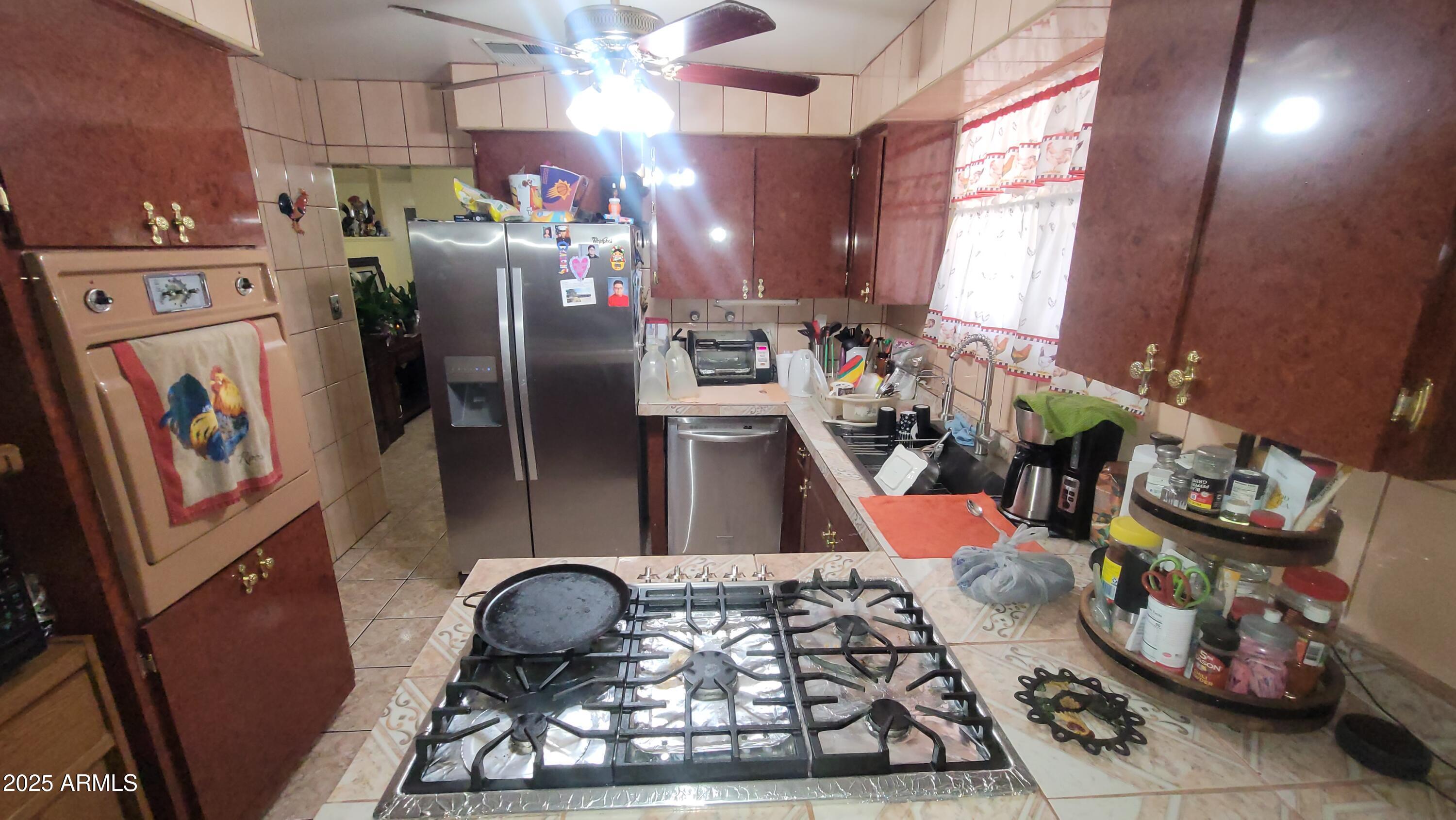 4315 West Osborn Road Phoenix, AZ 85031 - Photo 25 of 29 a kitchen with stainless steel appliances granite countertop a sink a stove and a refrigerator