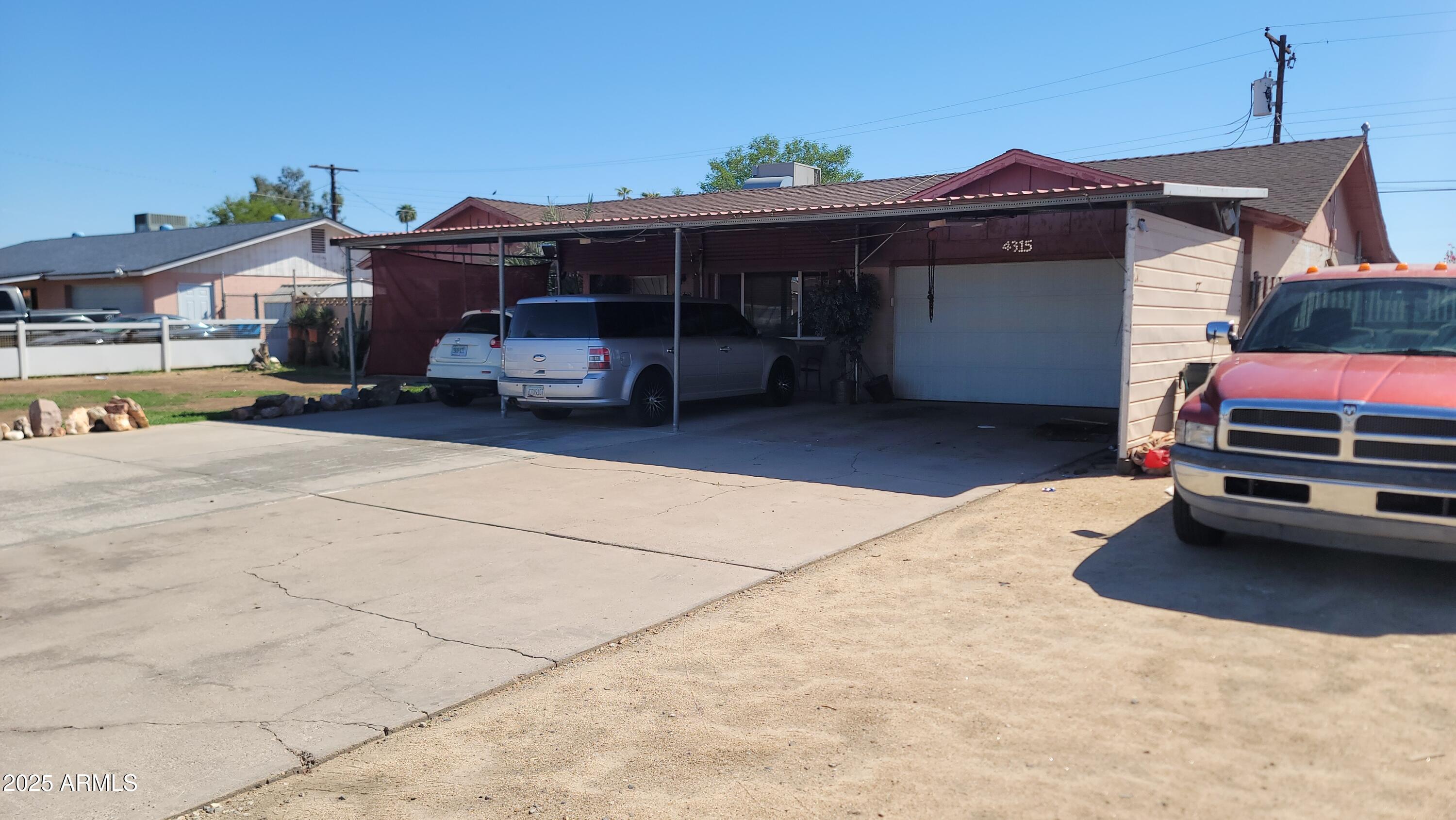 4315 West Osborn Road Phoenix, AZ 85031 - Photo 3 of 29 a car parked in front of house