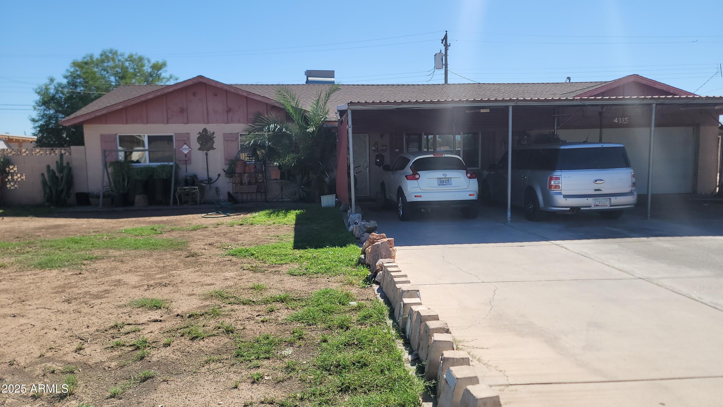 4315 West Osborn Road Phoenix, AZ 85031 - Photo 5 of 29 a front view of a house with yard and garage