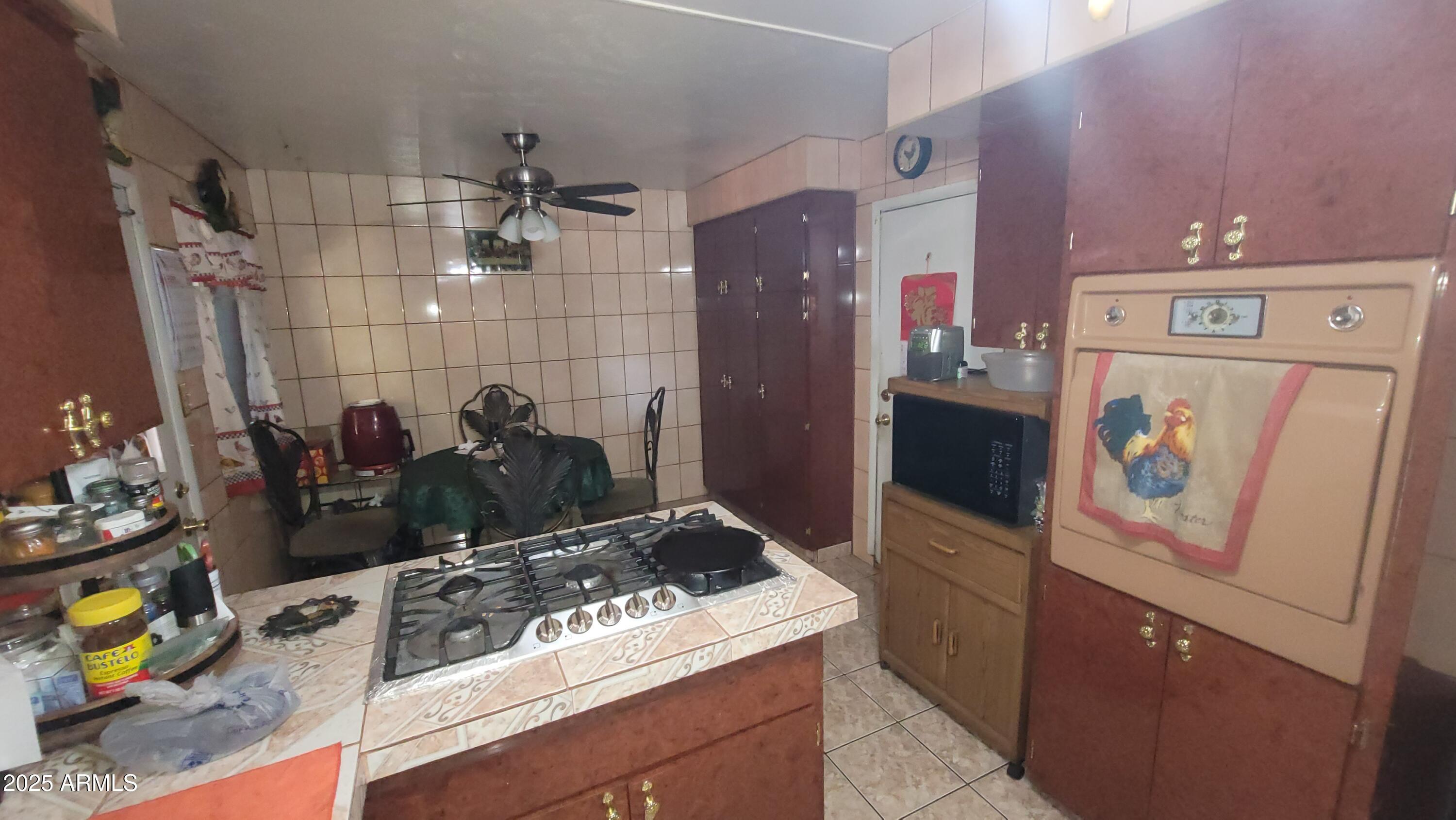 4315 West Osborn Road Phoenix, AZ 85031 - Photo 9 of 29 a kitchen with a stove and a refrigerator