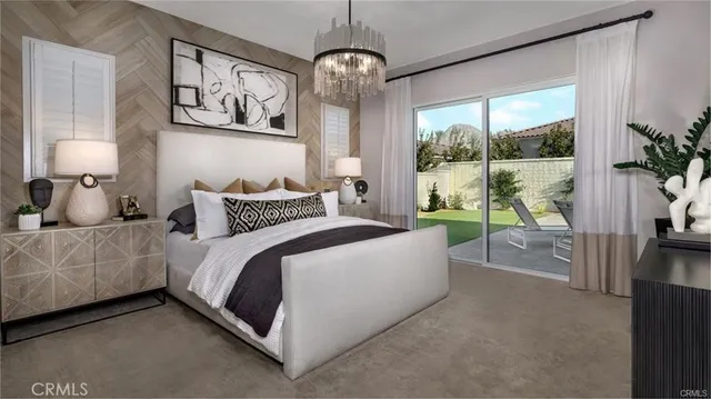 a bedroom with a large bed and a chandelier