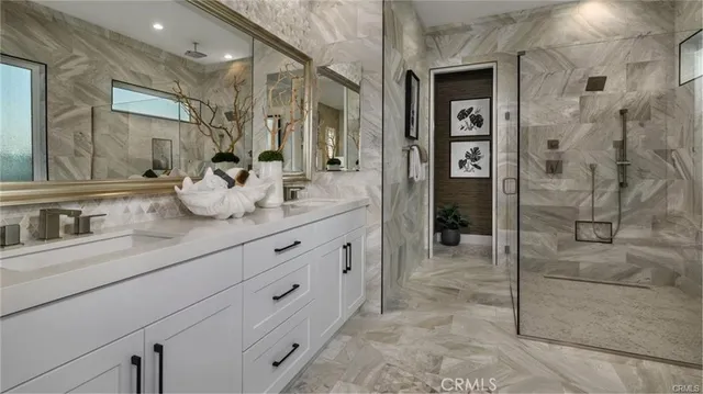 a bathroom with a granite countertop sink mirror and shower