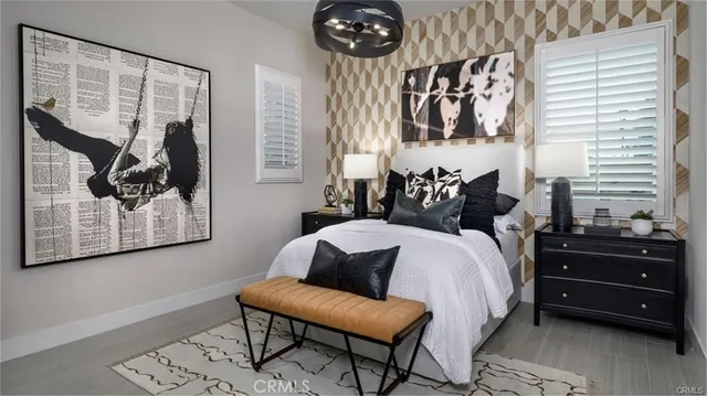 a bedroom with a bed and a painting on the wall