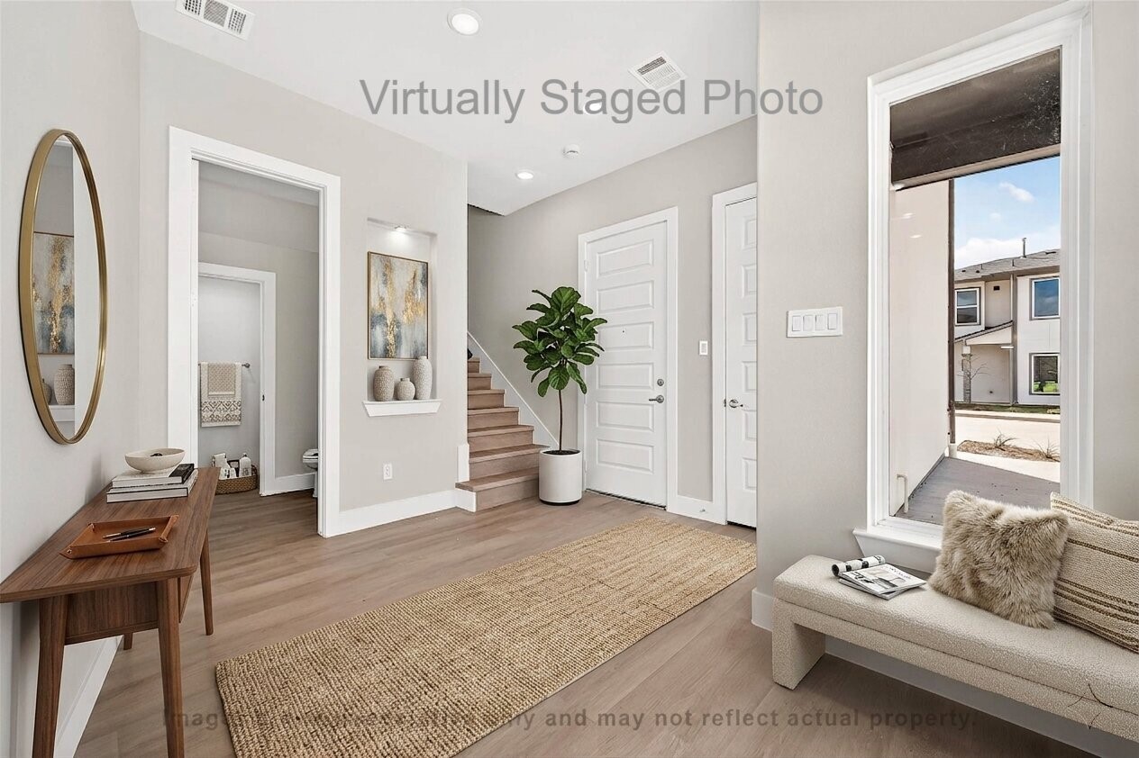 10719 Mason Road, Unit 15 Richmond, TX 77406 - Photo 13 of 50 Virtual Staging - Welcoming entryway featuring a wooden console table, a long woven runner rug, and a cozy bench situated by a large window