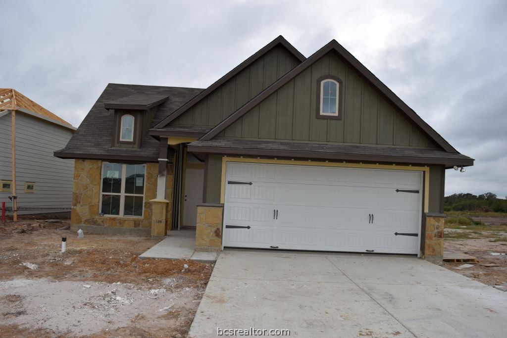 a front view of a house with garage