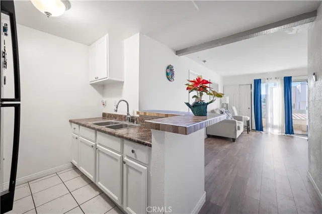 a en suite bathroom with a granite countertop sink and a mirror