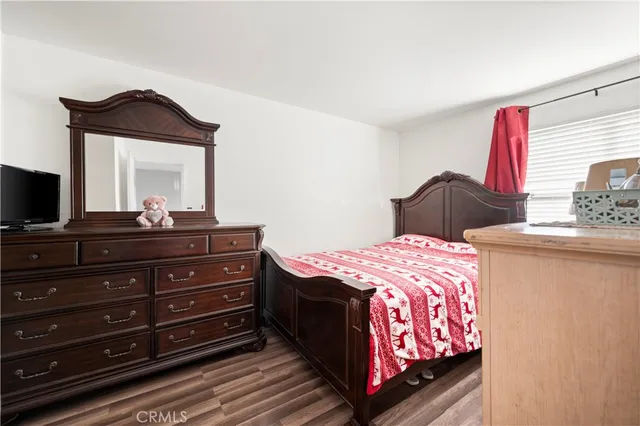 a bedroom with a bed and a dresser